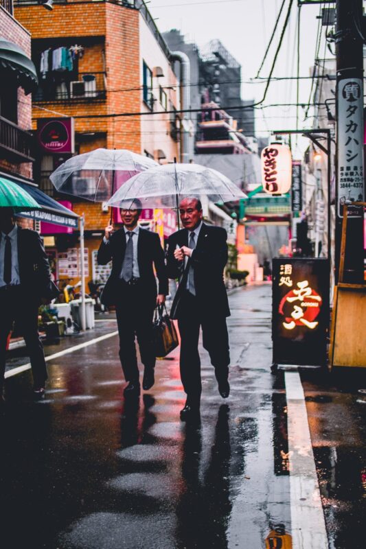 two older men walking in japan in suits, to illustrate age based job discrimination